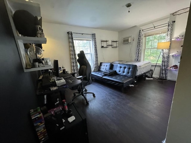 bedroom with dark hardwood / wood-style flooring and a wall unit AC