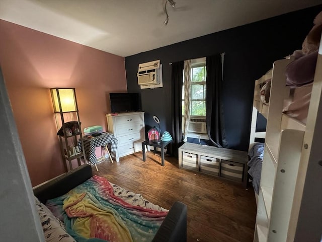 bedroom featuring cooling unit, dark wood-type flooring, and a wall mounted air conditioner