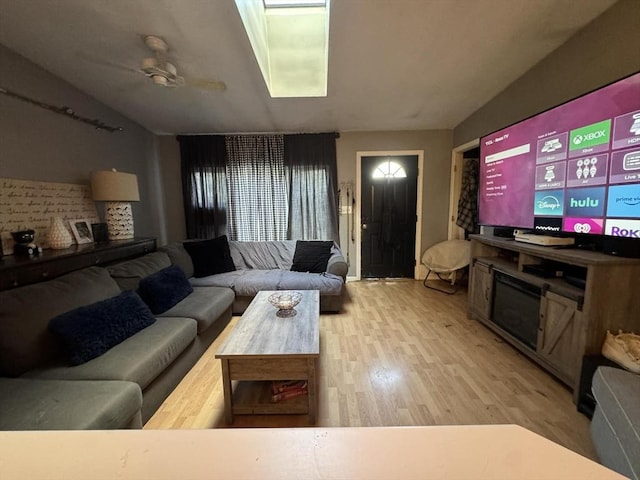 living room featuring wood-type flooring and ceiling fan