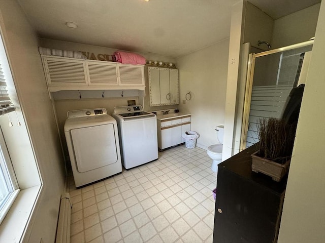 laundry area with washing machine and dryer, sink, and a baseboard radiator