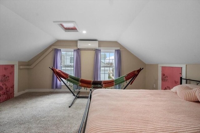 12 Salem St Unit 2, Haverhill, MA 01835 - bedroom with baseboards, vaulted ceiling, an AC wall unit, and carpet flooring