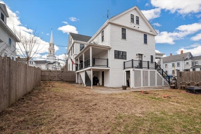 12 Salem St Unit 2, Haverhill, MA 01835 - back of property featuring stairs, a fenced backyard, a yard, and a patio area