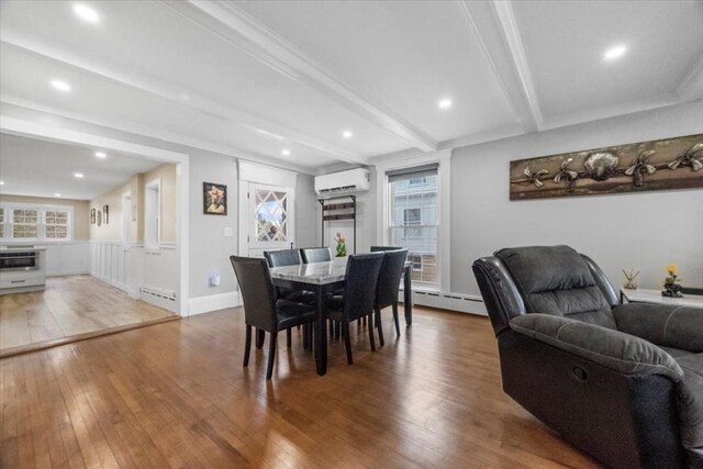 12 Salem St Unit 2, Haverhill, MA 01835 - dining area with a baseboard radiator, beamed ceiling, a wall unit AC, and hardwood / wood-style floors