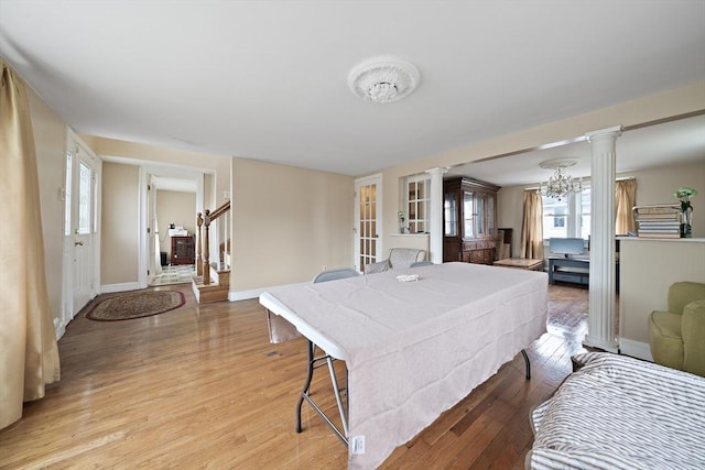 1 Chapin Cir, Randolph, MA 02368 - dining room with ornate columns, baseboards, light wood-style flooring, and stairway