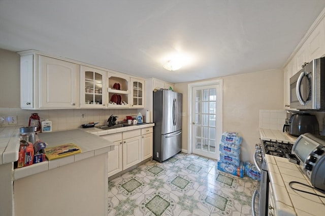 1 Chapin Cir, Randolph, MA 02368 - kitchen featuring tile counters, appliances with stainless steel finishes, a sink, and decorative backsplash