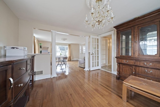 1 Chapin Cir, Randolph, MA 02368 - entryway featuring hardwood / wood-style floors, ornate columns, baseboards, and a chandelier