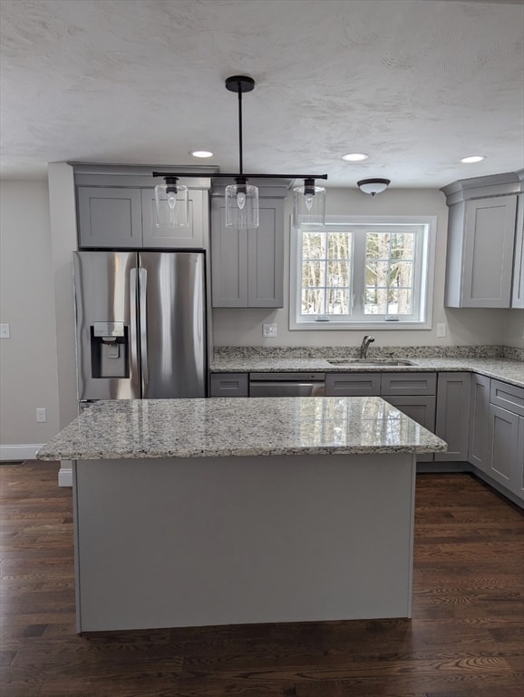 kitchen featuring appliances with stainless steel finishes, sink, dark hardwood / wood-style floors, and gray cabinets