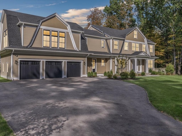 view of front of house with a garage and a front yard