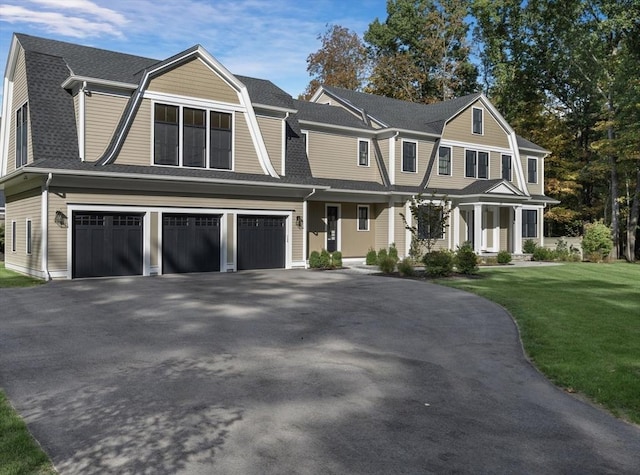 view of front of house with a front yard and a garage