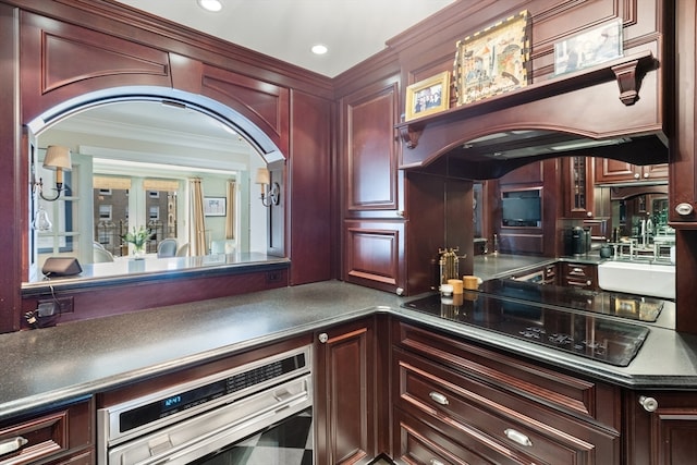 kitchen with ornamental molding, black electric stovetop, sink, and oven