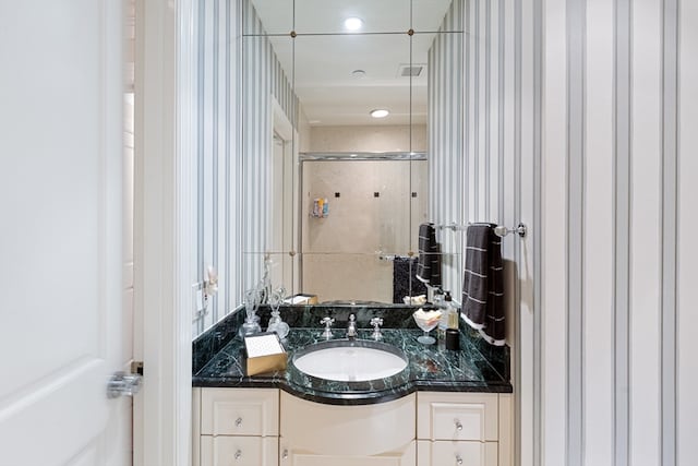 bathroom featuring an enclosed shower and vanity