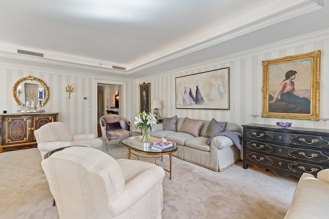 living room with ornamental molding, light colored carpet, and a tray ceiling