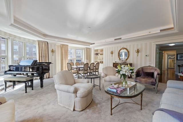 carpeted living room featuring crown molding and a raised ceiling