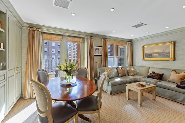 dining space with light colored carpet and ornamental molding