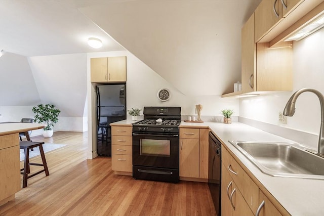 61 Crescent St Unit 6, Northampton, MA 01060 - kitchen featuring black appliances, a sink, light brown cabinets, light countertops, and lofted ceiling