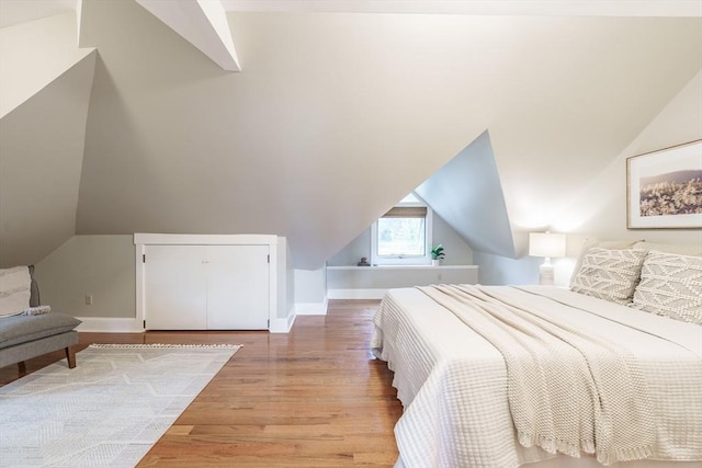 61 Crescent St Unit 6, Northampton, MA 01060 - bedroom featuring vaulted ceiling, wood finished floors, and baseboards