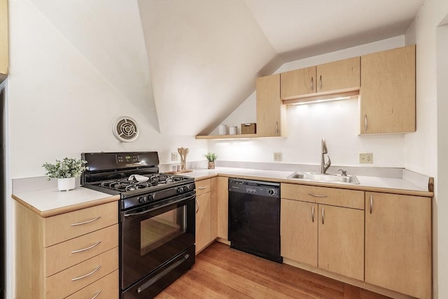 61 Crescent St Unit 6, Northampton, MA 01060 - kitchen with black appliances, light brown cabinets, a sink, light wood-style floors, and vaulted ceiling