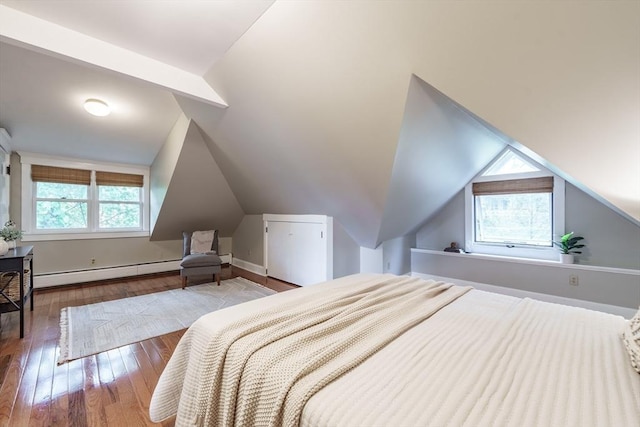 61 Crescent St Unit 6, Northampton, MA 01060 - bedroom with a baseboard heating unit, lofted ceiling, and wood-type flooring