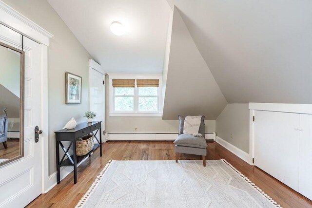61 Crescent St Unit 6, Northampton, MA 01060 - sitting room featuring a baseboard heating unit, wood finished floors, lofted ceiling, and baseboards