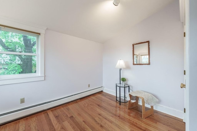 61 Crescent St Unit 6, Northampton, MA 01060 - spare room featuring baseboard heating, light wood finished floors, vaulted ceiling, and baseboards
