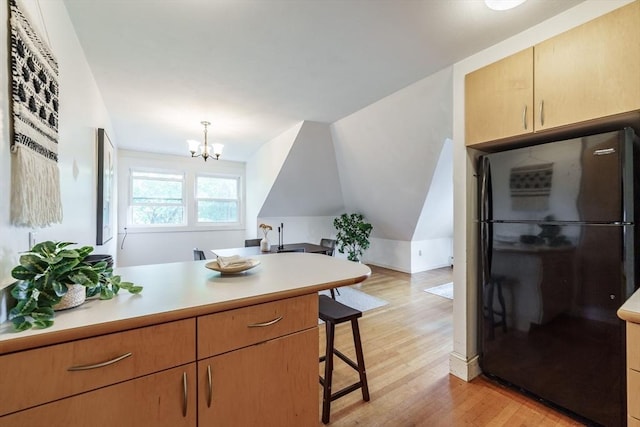 61 Crescent St Unit 6, Northampton, MA 01060 - kitchen with freestanding refrigerator, a peninsula, light wood finished floors, light countertops, and lofted ceiling