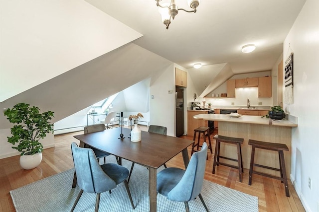 61 Crescent St Unit 6, Northampton, MA 01060 - dining area with a baseboard heating unit, light wood-type flooring, lofted ceiling, and baseboards