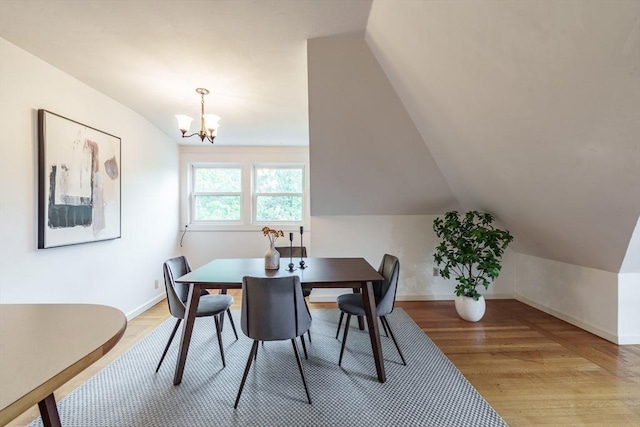 61 Crescent St Unit 6, Northampton, MA 01060 - dining room featuring a chandelier, light wood finished floors, vaulted ceiling, and baseboards