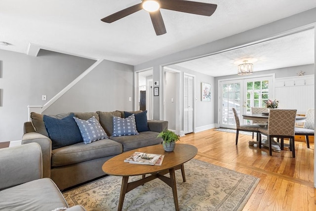 212 Broadway St, Wakefield, MA 01880 - living room featuring light wood-style floors, ceiling fan, stairway, and baseboards