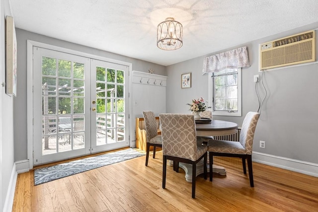 212 Broadway St, Wakefield, MA 01880 - dining room featuring french doors, a chandelier, wood finished floors, a wall unit AC, and baseboards
