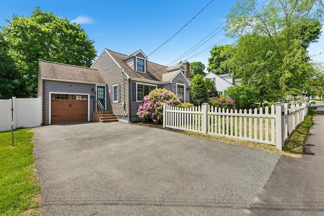 212 Broadway St, Wakefield, MA 01880 - cape cod home with a garage, driveway, and roof with shingles