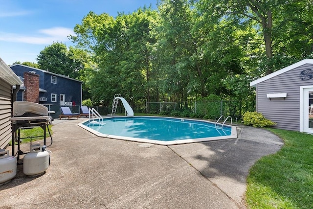 212 Broadway St, Wakefield, MA 01880 - view of swimming pool featuring a water slide, a patio area, and view of wooded area