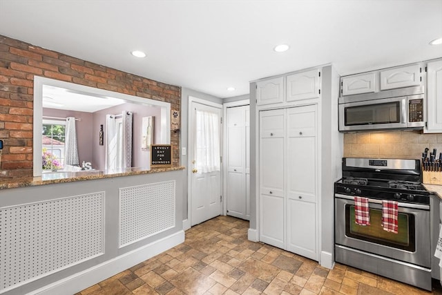212 Broadway St, Wakefield, MA 01880 - kitchen with appliances with stainless steel finishes, tasteful backsplash, light stone finish floors, and recessed lighting