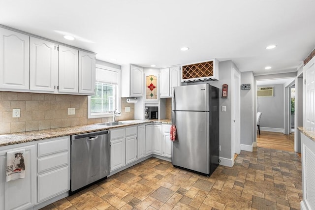 212 Broadway St, Wakefield, MA 01880 - kitchen featuring appliances with stainless steel finishes, baseboards, a sink, recessed lighting, and tasteful backsplash