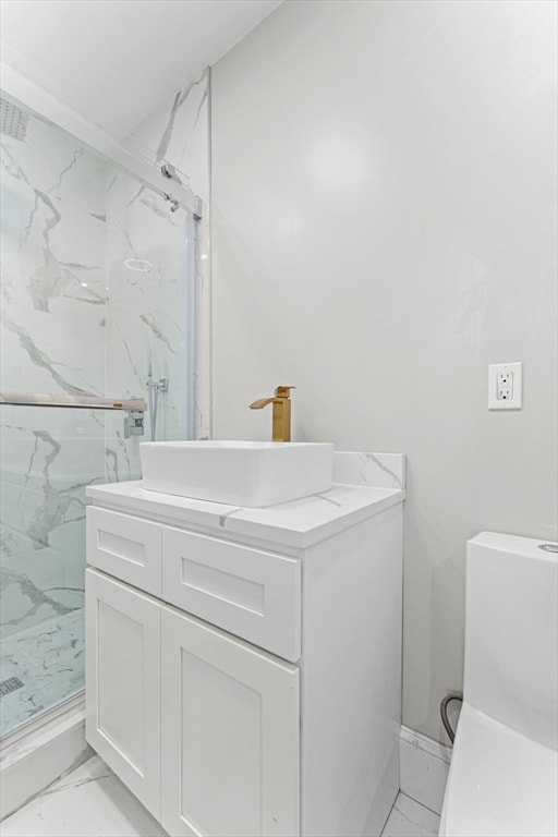 bathroom with vanity and a shower with shower door