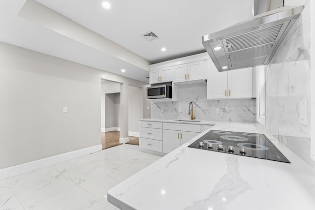 kitchen with black electric cooktop, white cabinetry, extractor fan, and sink