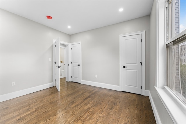 unfurnished bedroom featuring dark hardwood / wood-style flooring