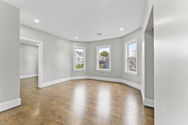 unfurnished room with dark hardwood / wood-style floors