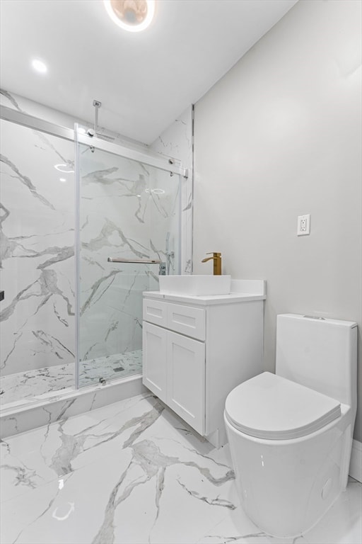 bathroom featuring a shower with shower door, vanity, and toilet