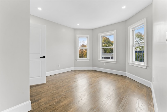 unfurnished room featuring hardwood / wood-style flooring