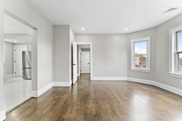 spare room featuring dark hardwood / wood-style flooring