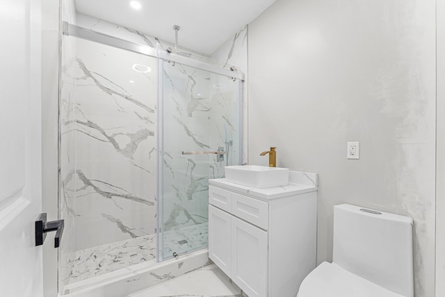 bathroom featuring vanity, toilet, and a shower with shower door