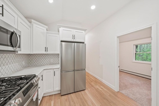 kitchen with a baseboard radiator, light countertops, white cabinetry, decorative backsplash, and stainless steel appliances