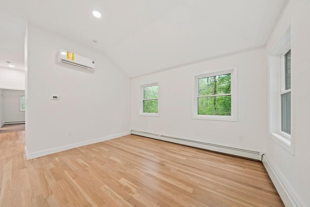 empty room with a wall unit AC, light wood-type flooring, baseboards, baseboard heating, and vaulted ceiling