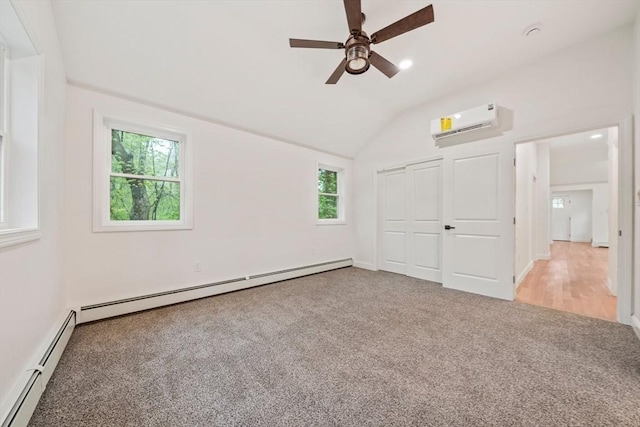 unfurnished bedroom featuring vaulted ceiling, a baseboard radiator, a wall mounted AC, and carpet flooring