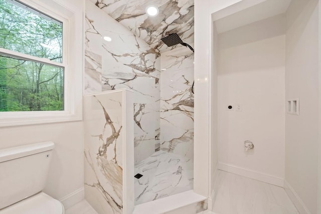 full bath with toilet, a marble finish shower, marble finish floor, and baseboards