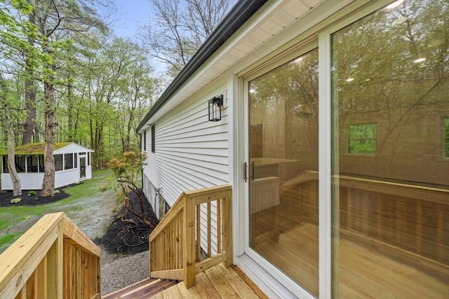 wooden deck featuring a sunroom
