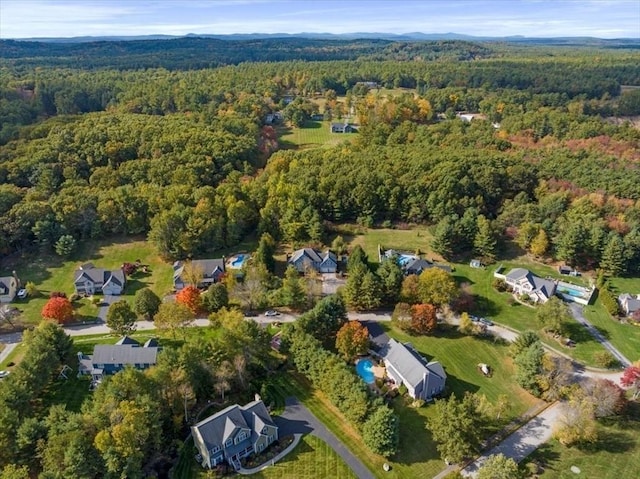 aerial view featuring a wooded view