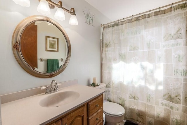 bathroom featuring vanity, curtained shower, and toilet