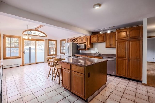 kitchen with stainless steel appliances, a baseboard radiator, vaulted ceiling with beams, a notable chandelier, and a kitchen island