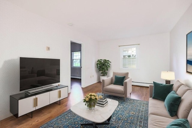 living room with baseboard heating and dark hardwood / wood-style flooring